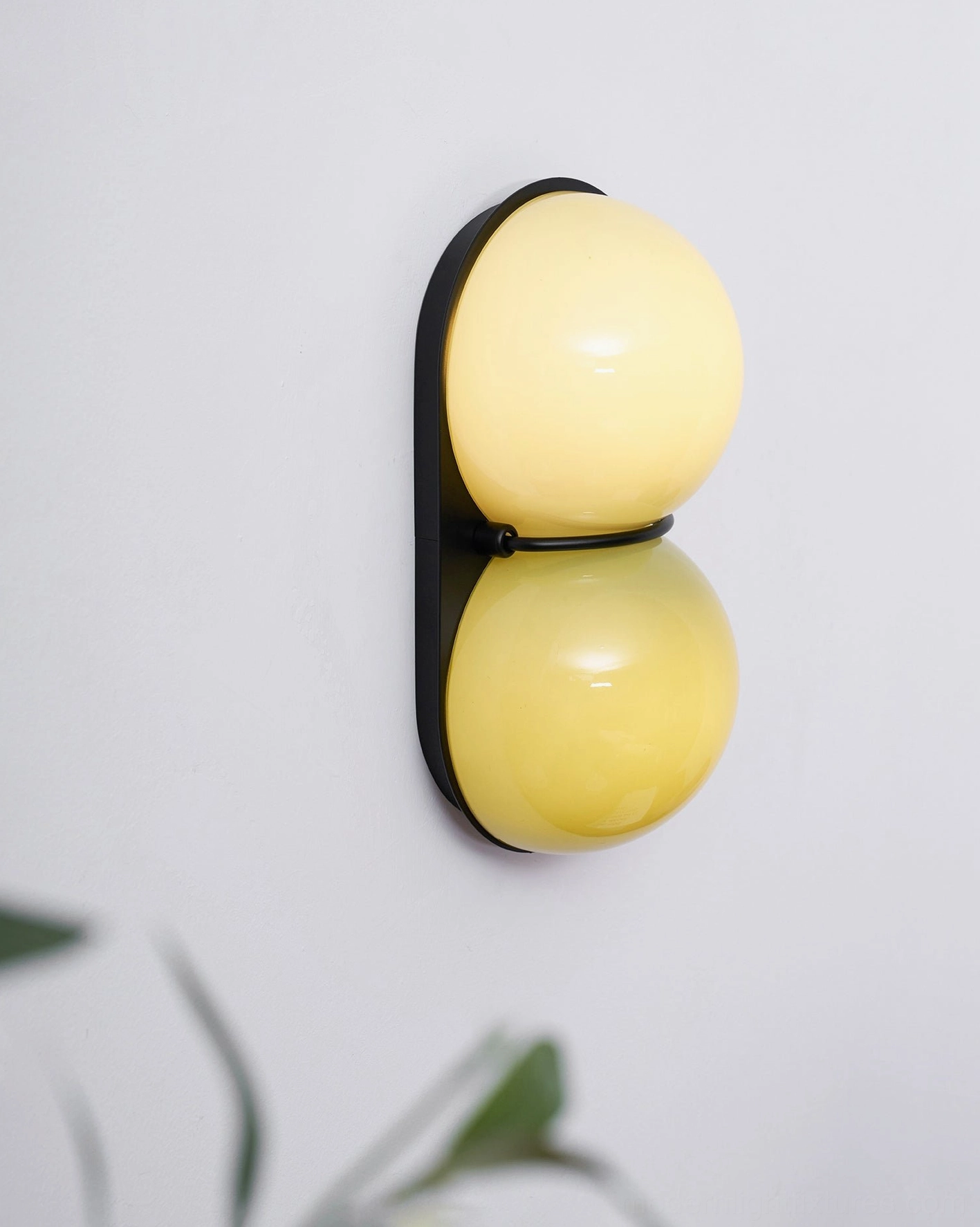 Modern wall sconce Twinwave with dual luminous glass orbs and refined minimalist frame design