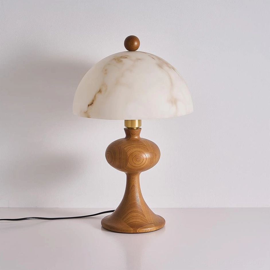 Modern wood table lamp with marble-veined alabaster shade and brass accents, three-quarter view displaying natural wood grain and power cord