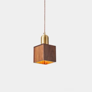 Modern walnut wood pendant light with brass fixture front view studio shot
