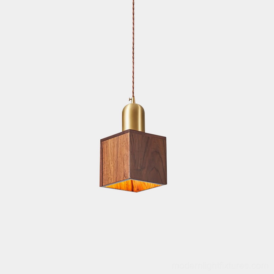 Modern walnut wood pendant light with brass fixture front view studio shot