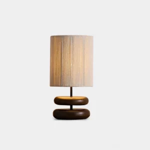 Modern walnut wood stacked base table lamp with beige fabric shade front view on white background