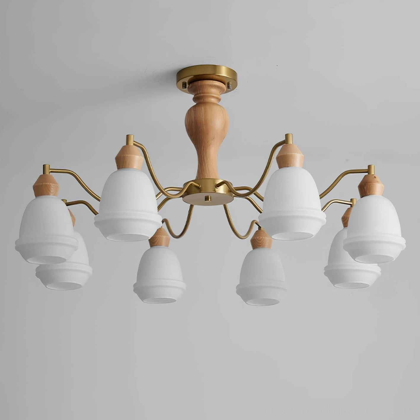 Modern wood and brass chandelier with multiple frosted glass shades illuminated