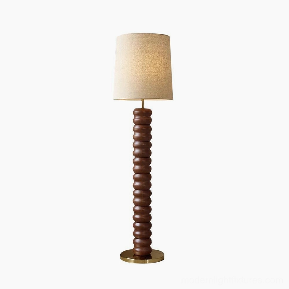 Contemporary stacked wood floor lamp with linen shade creating warm ambient light in modern interior