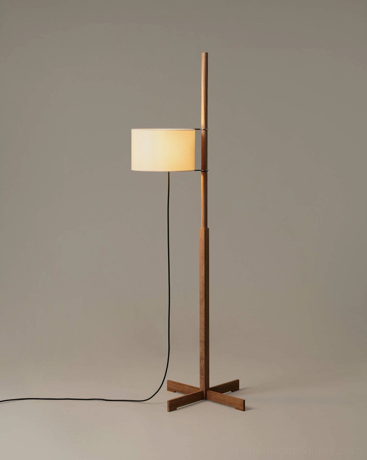 Contemporary wood floor lamp with elegant cross-legged base in modern interior setting