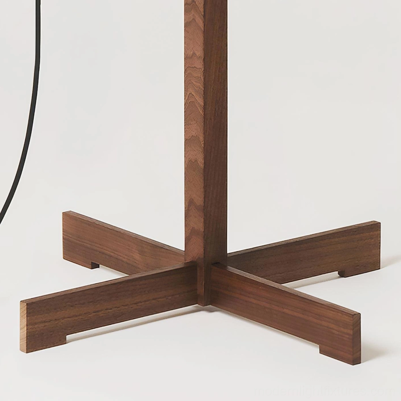 Modern wooden floor lamp with cross base in contemporary home, interior design accent piece