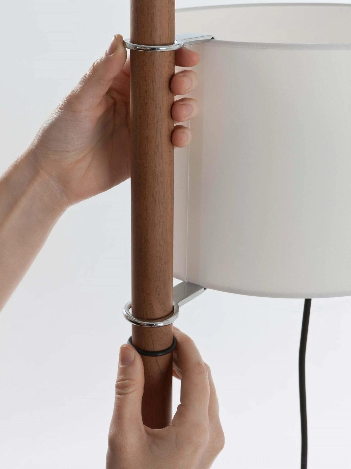 Modern floor lamp with wooden column and white shade in Scandinavian style interior