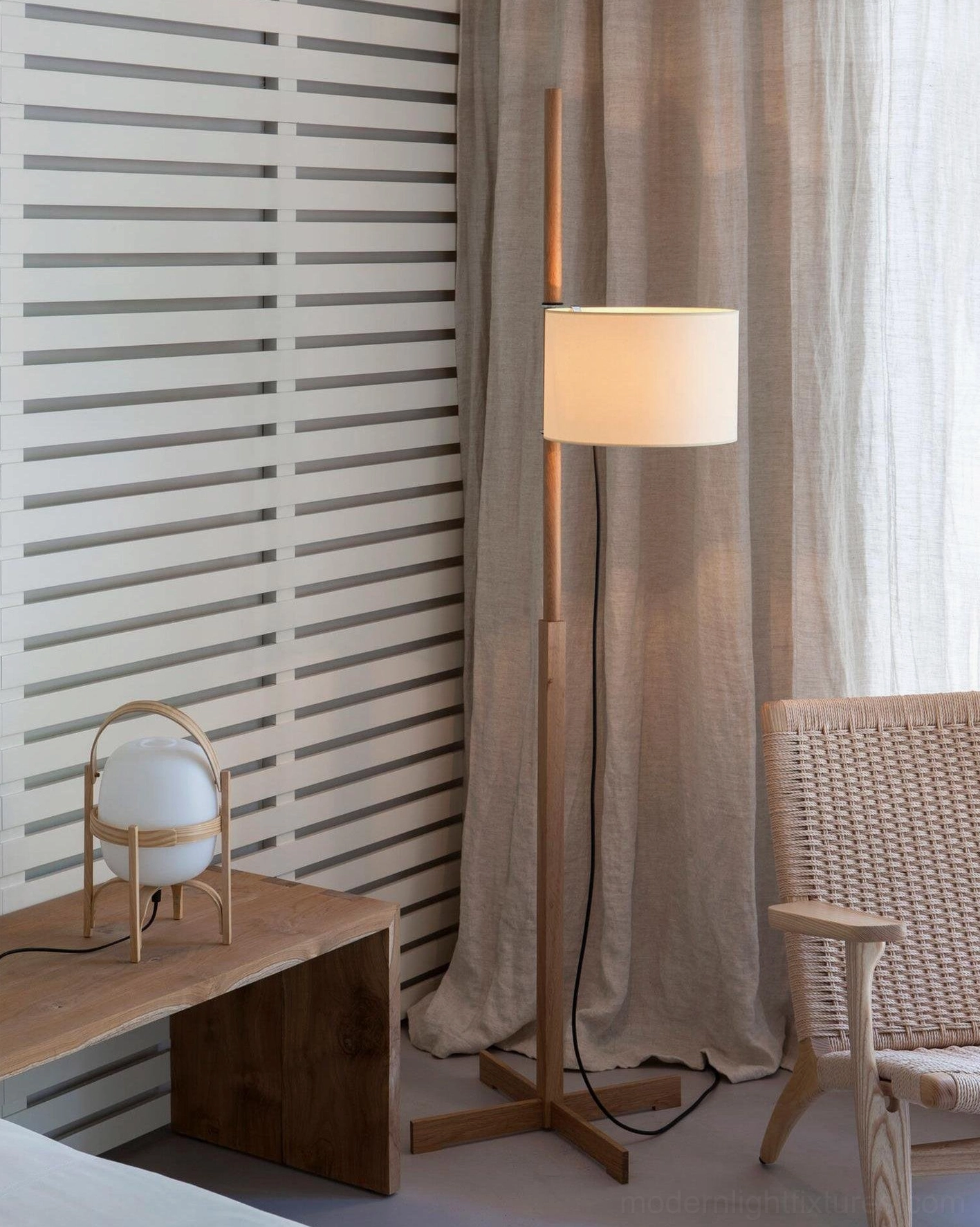 Modern floor lamp with wooden pole and fabric shade, detail view of lamp head and base