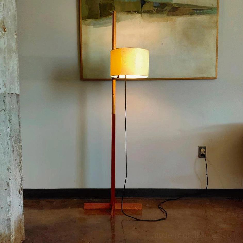 Warm reddish-brown wood floor lamp with yellow fabric shade in cozy minimalist living room