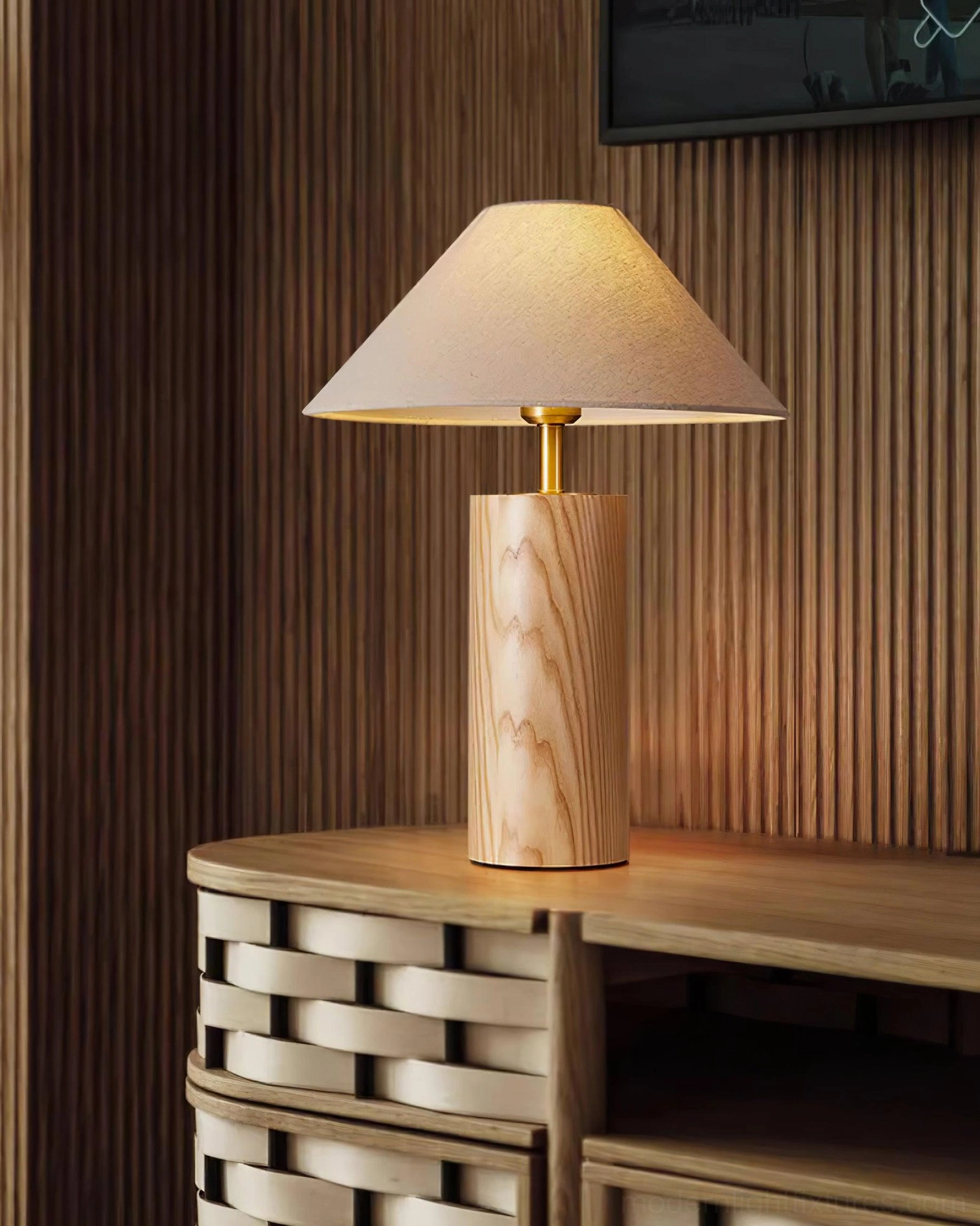 Light wood table lamp paired with woven cabinet and wall panels in Scandinavian interior