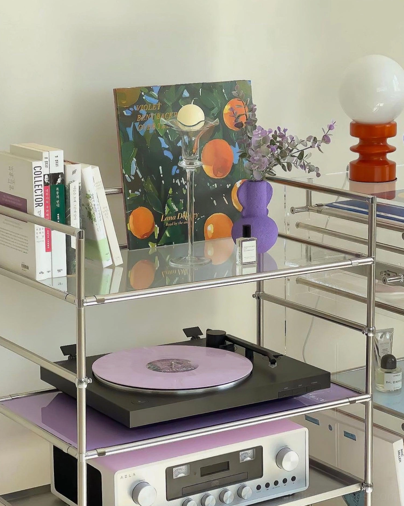 Mid-century modern wood table lamp displayed on glass shelf with vinyl records and books