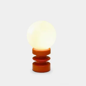 Modern accordion pleated wood table lamp with spherical glass shade on white studio background