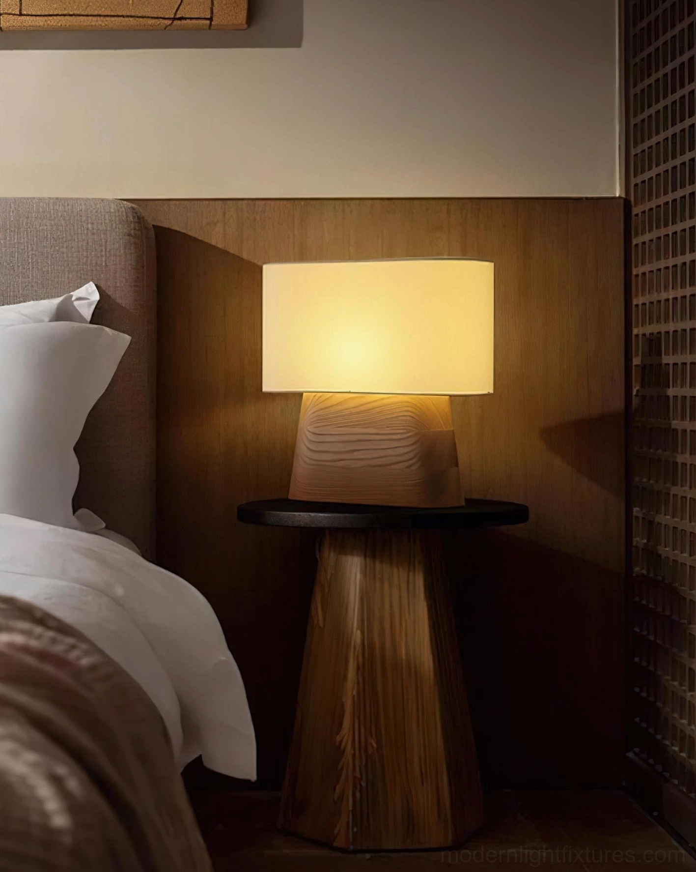 Illuminated wood table lamp creating warm ambient light on bedroom accent wall