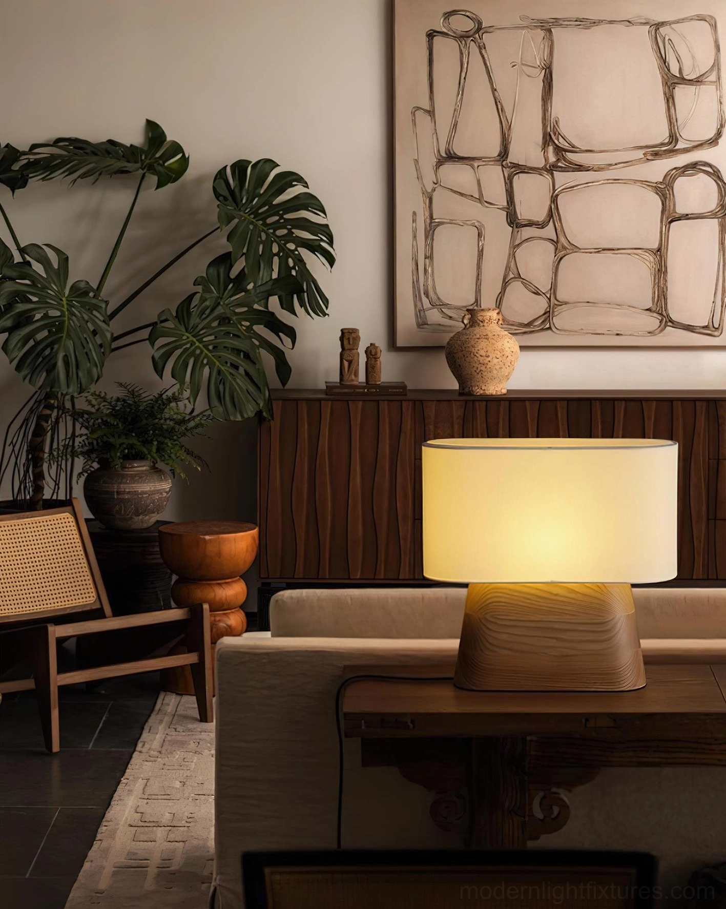 Light wood base table lamp with beige fabric shade in modern living room with plants