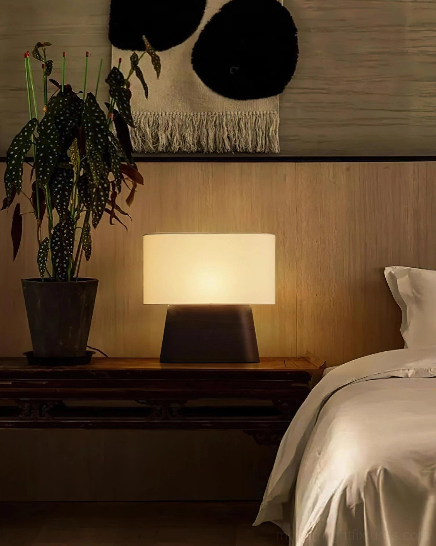 Modern wood table lamp beside sofa providing ambient lighting in cozy lounge area