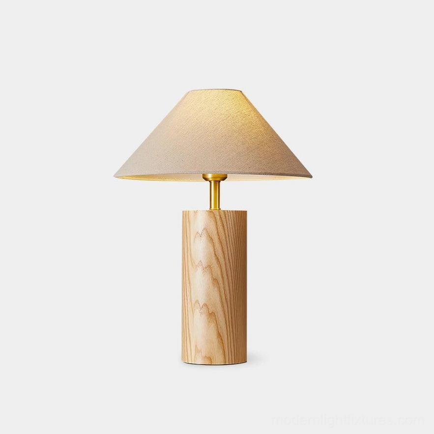 Modern walnut wood table lamp with brass neck and beige fabric shade, front view on white background
