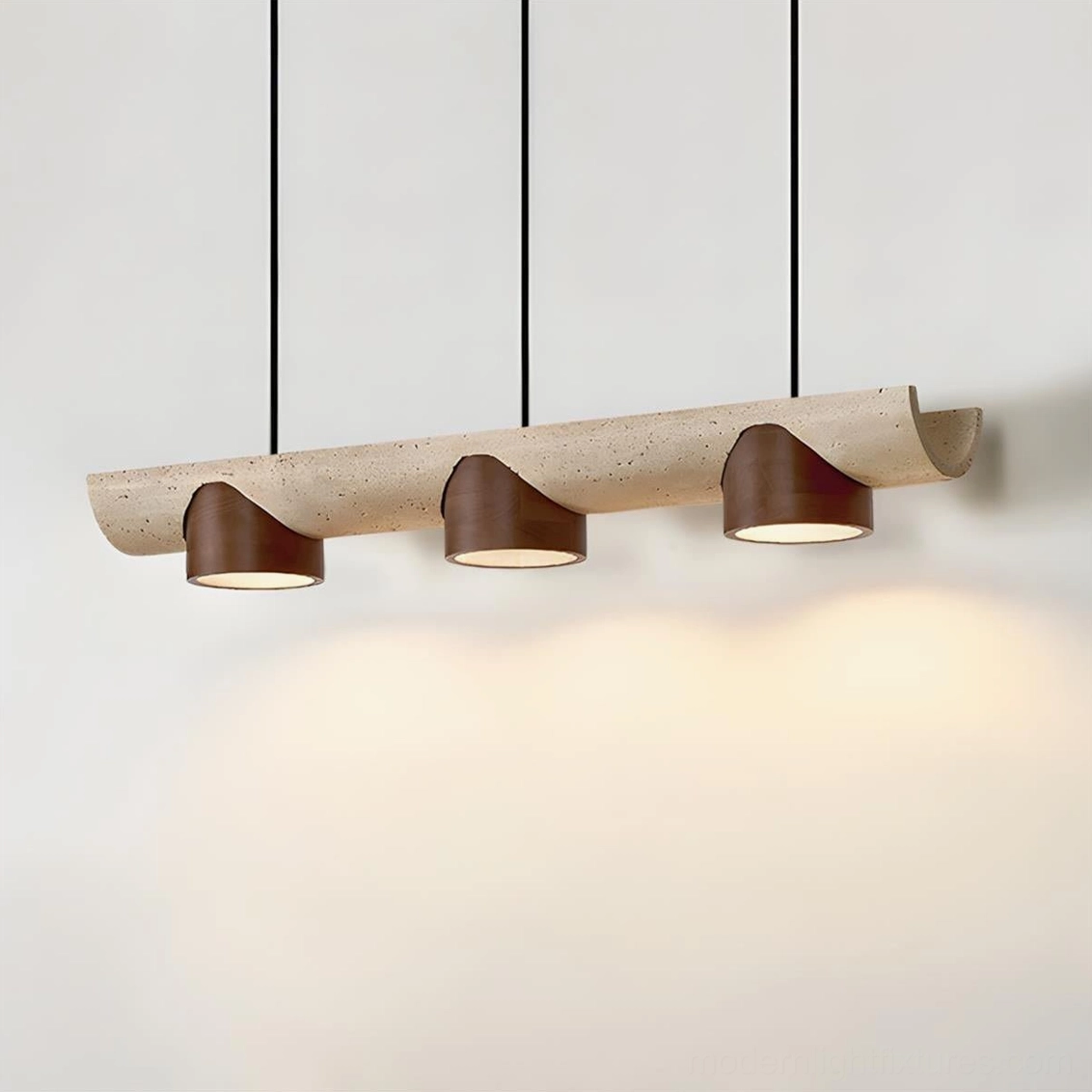 Modern pendant chandelier with curved travertine base and glowing warm light creating rustic minimalist ambiance