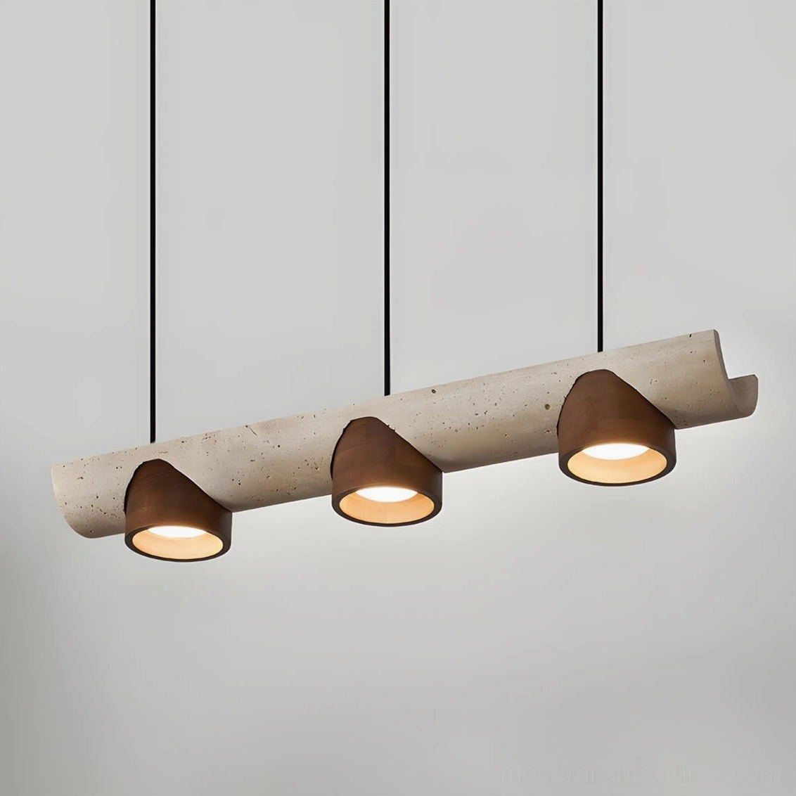 Close-up view of illuminated Modira pendant chandelier showing natural travertine texture and lit wooden shades