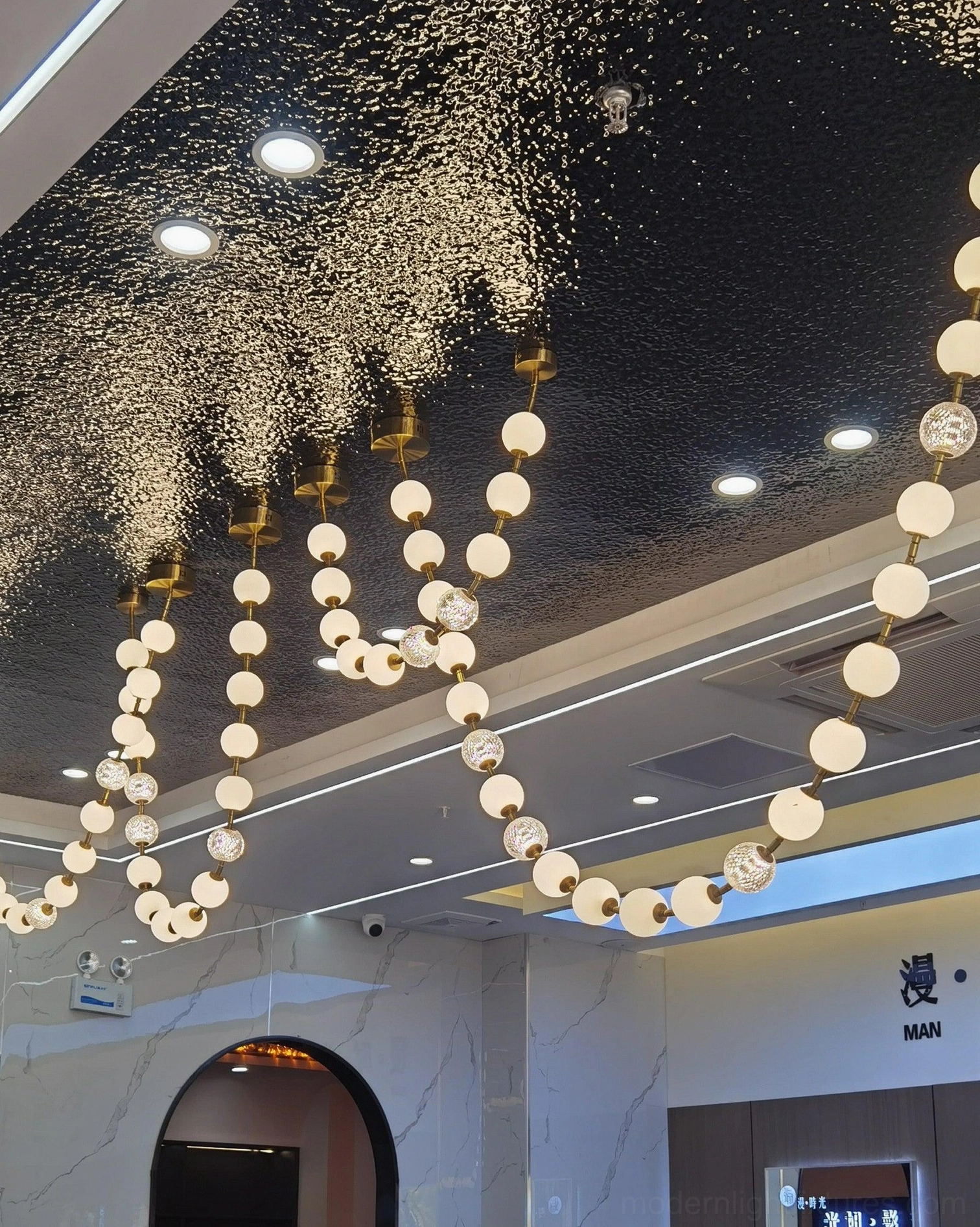 Contemporary pearl necklace chandelier with modular configuration options for custom installations