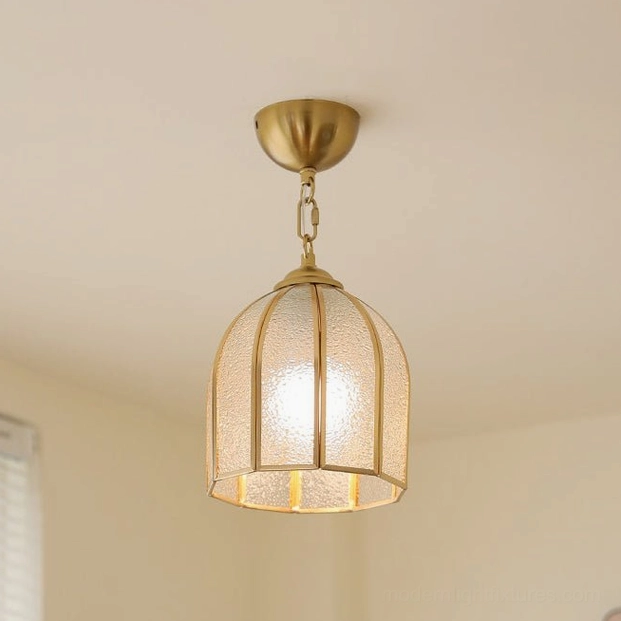 Lit moire brass ceiling lamp with frosted glass close-up front view glowing