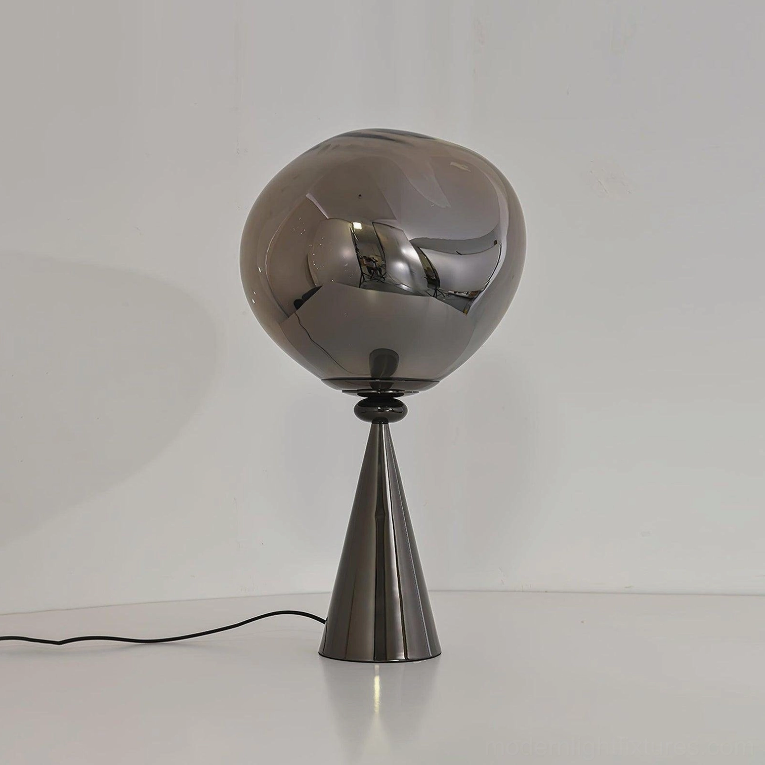 Gold-tinted molten glass cone lamp black tapered base tabletop display warm illumination