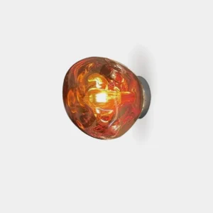 Molten glass wall sconce with organic amber shade on white background, front close-up view