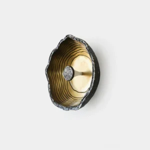 Moltena black wall sconce with hand-formed molten metal design, front studio product shot showcasing distressed black finish and brass interior