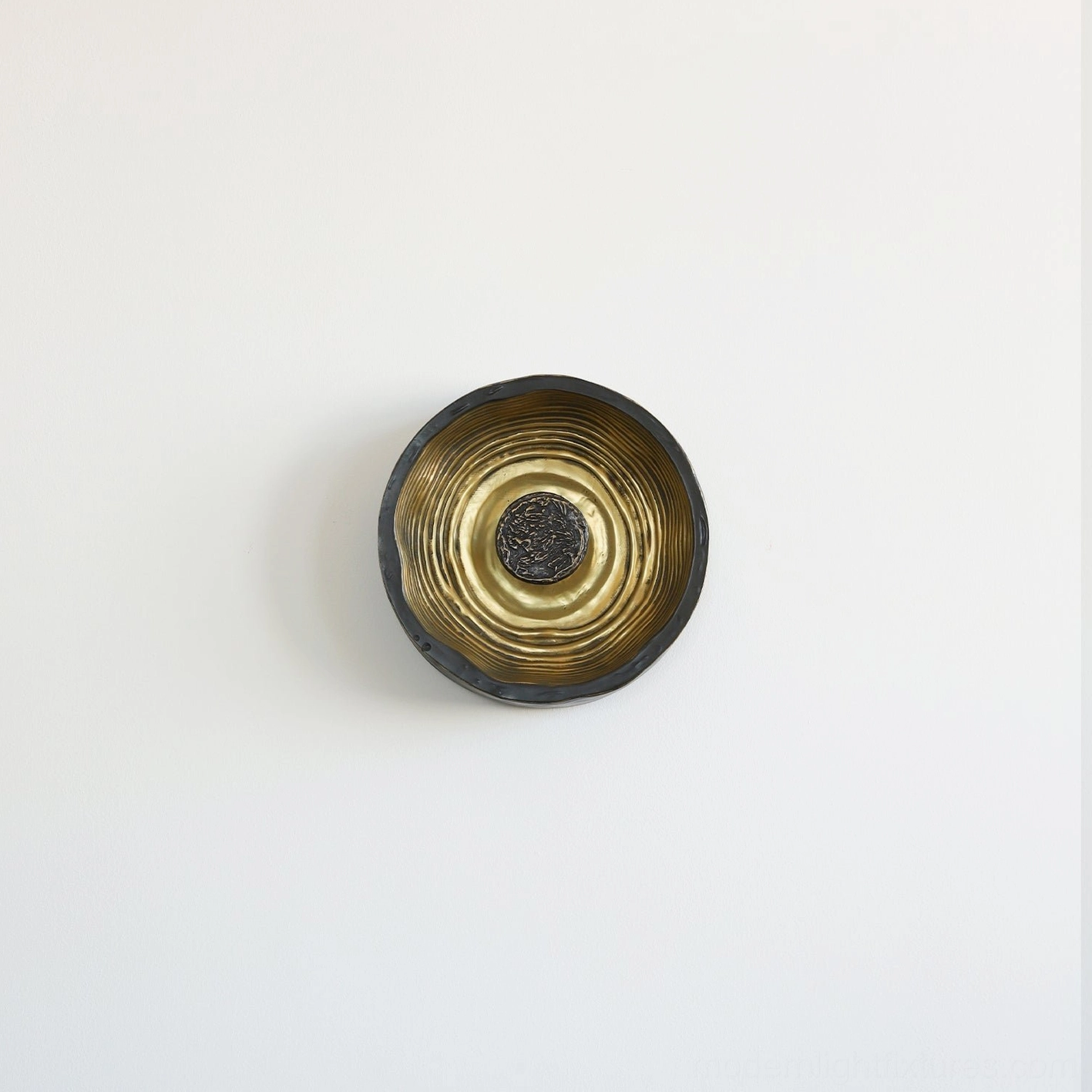 Modern Moltena black and brass wall sconce mounted in residential interior, functional artwork for contemporary home design
