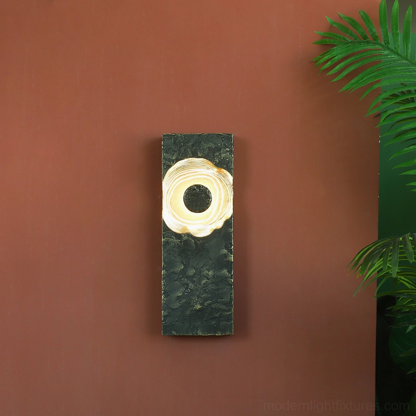Moltena wall lamp interior detail, polished brass golden reflective surface creating theatrical lighting effects