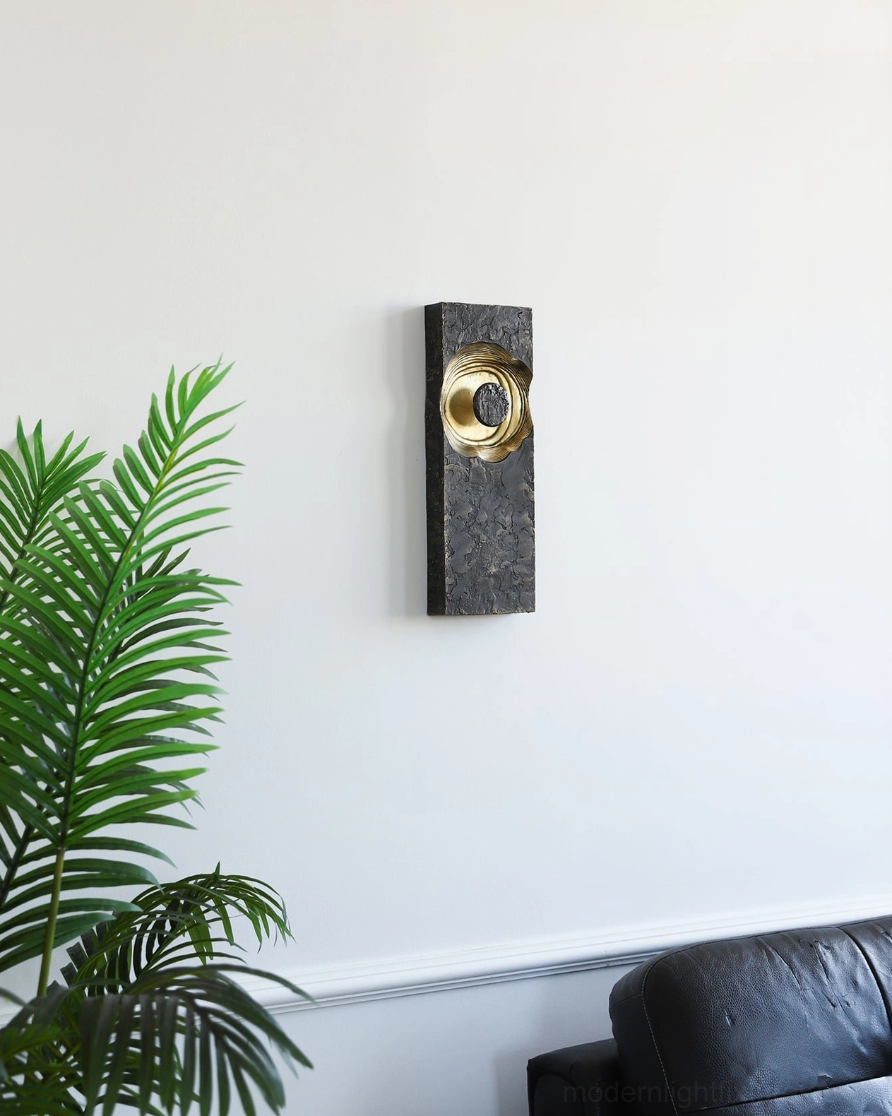 Moltena black wall sconce gallery arrangement, multiple sizes creating cohesive artistic lighting scheme in modern home