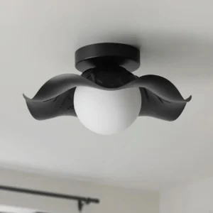 Monae semi-flush ceiling light close-up overhead showing white frosted glass globe with black metal petal shade