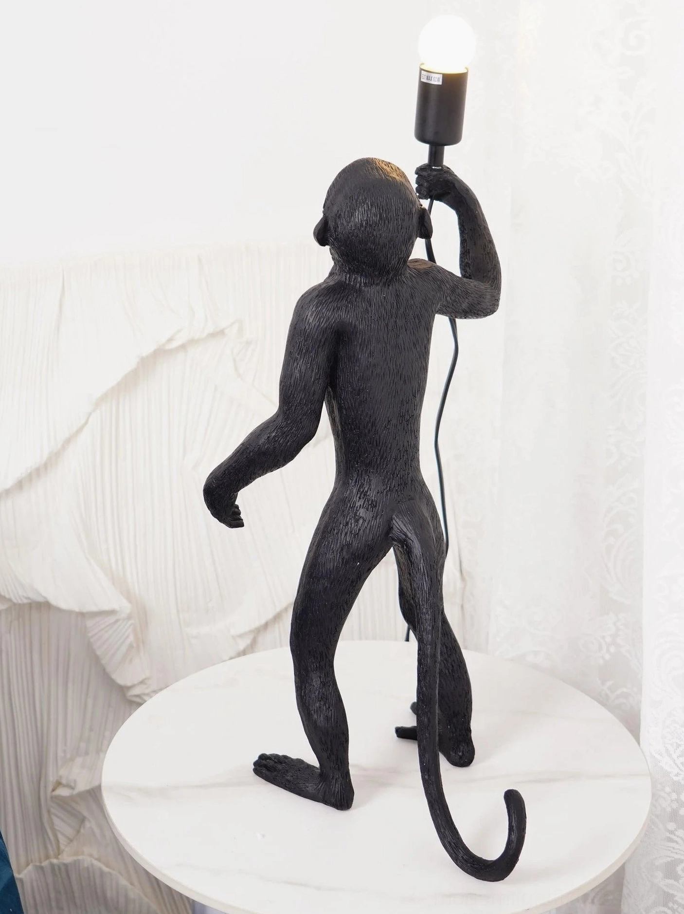 Monkey table lamp metal and resin construction detail view