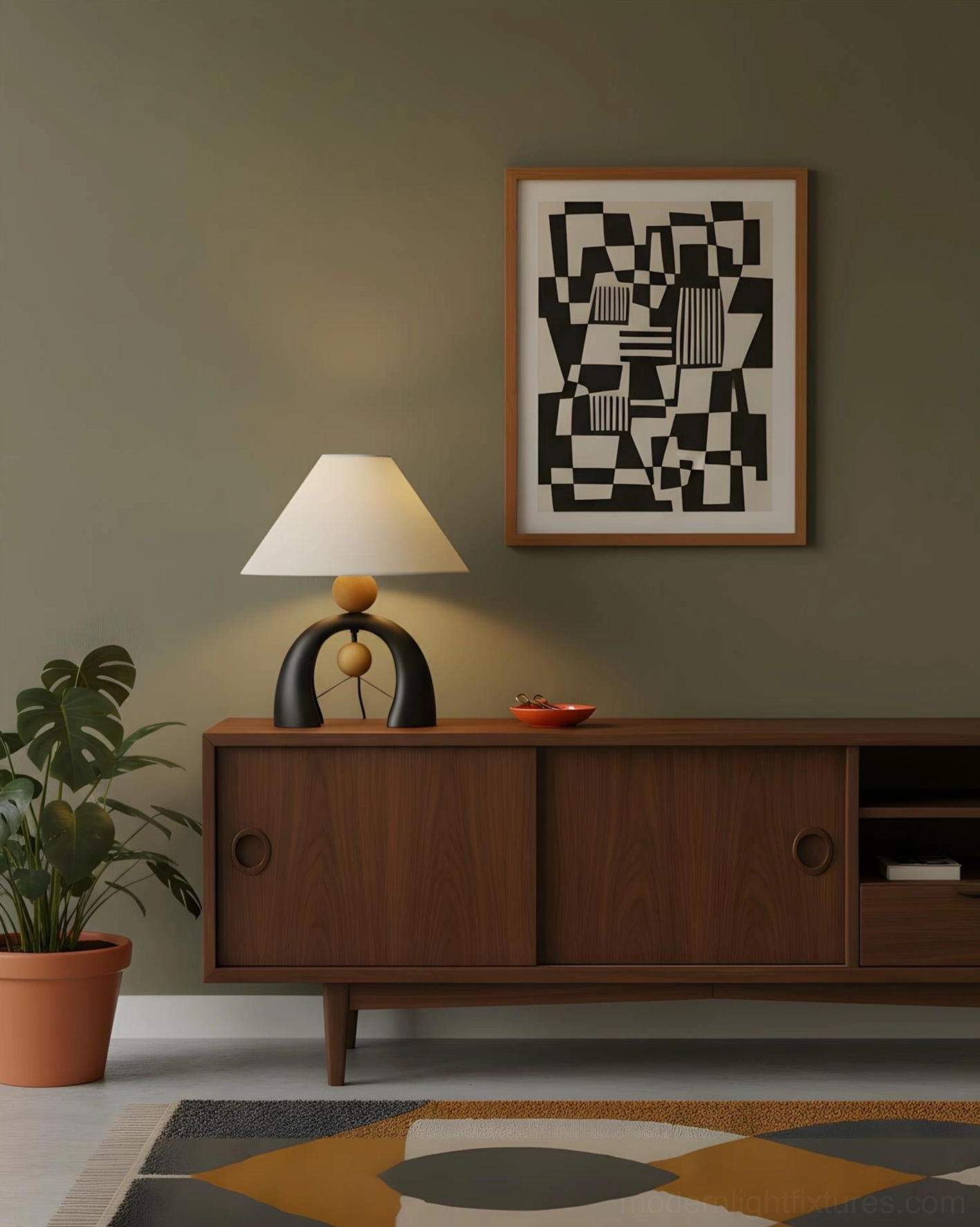 Arch table lamp bedroom styling on sideboard with muted green accent wall and dark wood storage cabinet