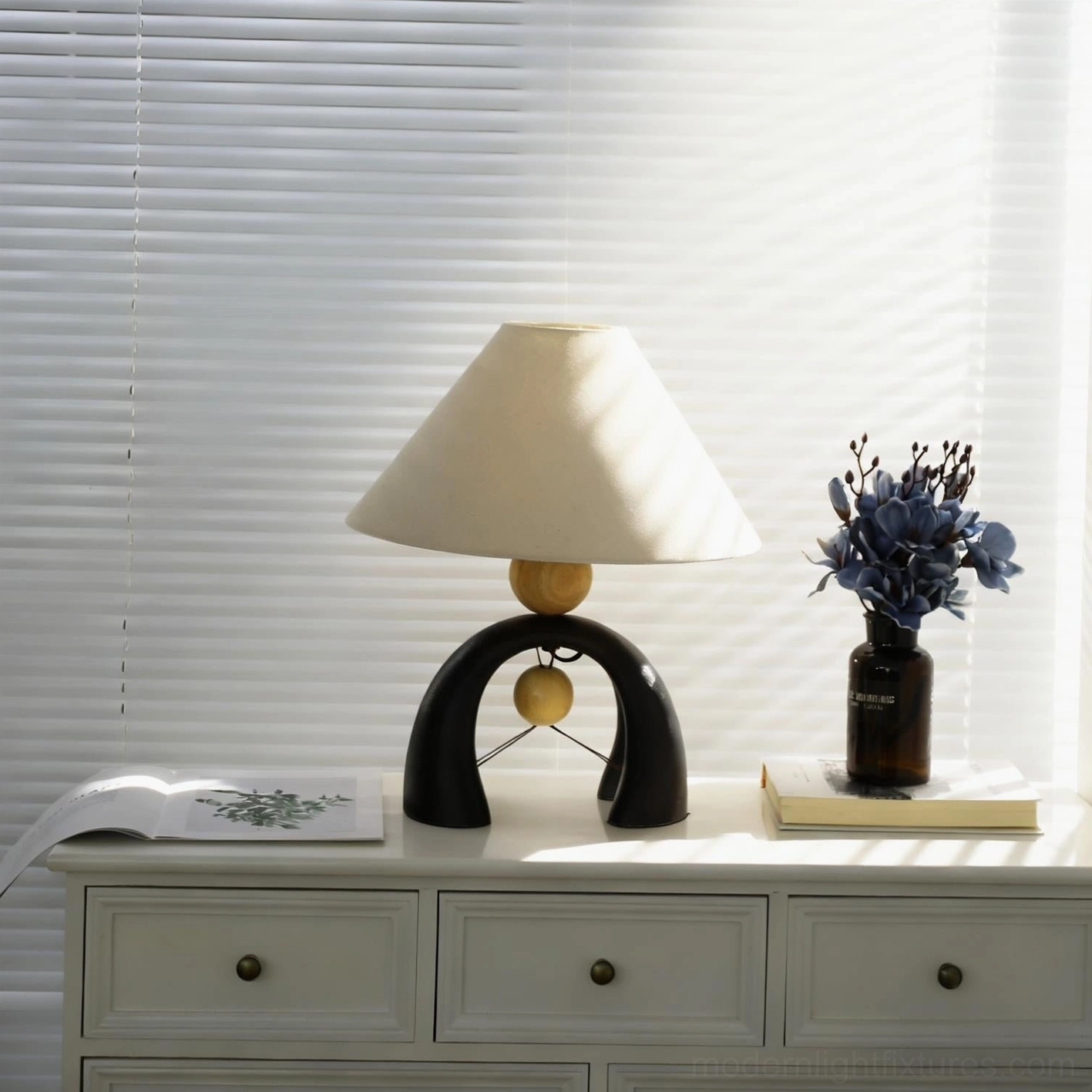 Mono Arch table lamp detail shot highlighting craftsmanship of resin base wooden spheres and metal accents