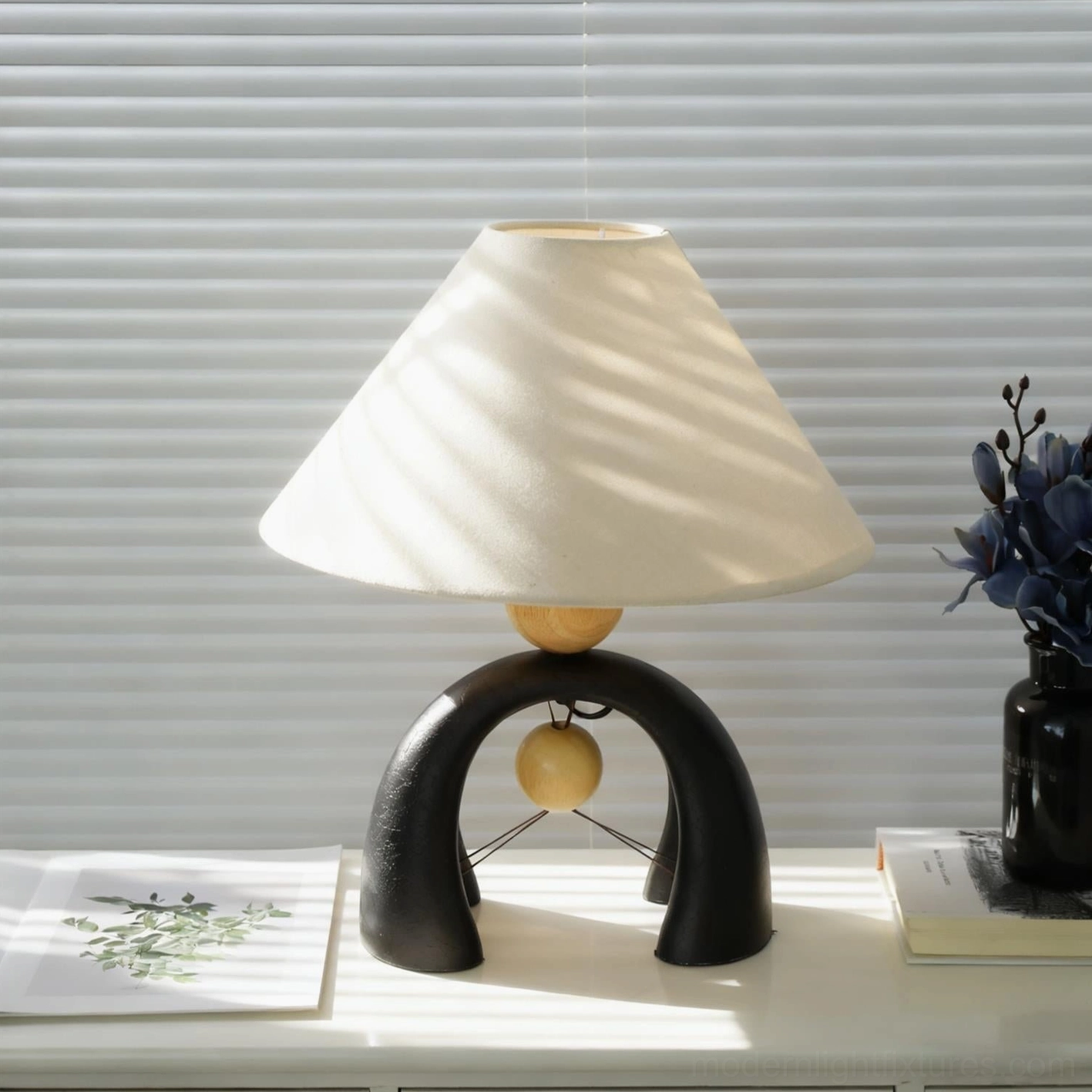 Modern sculptural arch table lamp full-length view displaying proportions and overall design aesthetic