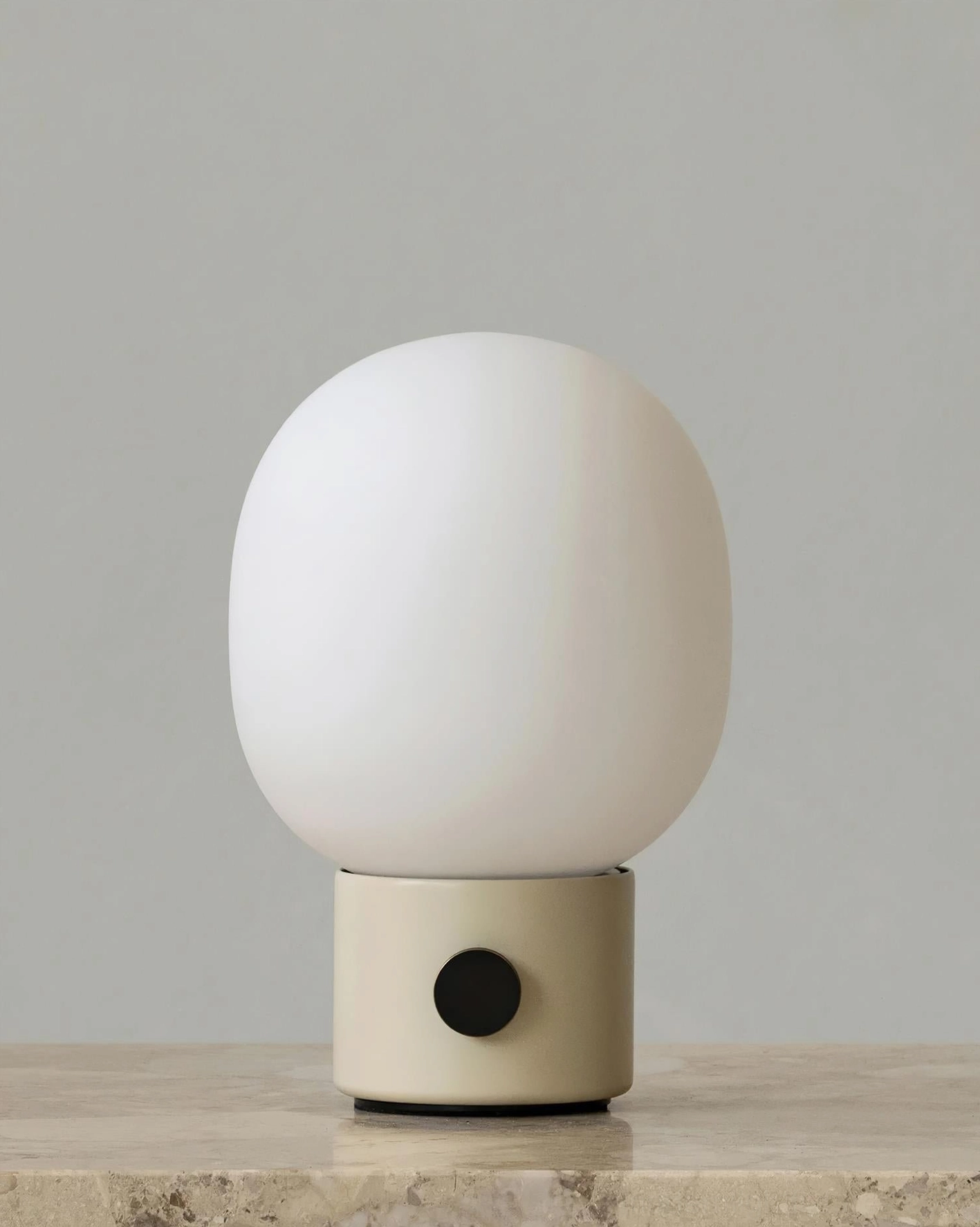 Off-white Monolith minimalist table lamp with black toggle switch and frosted shade