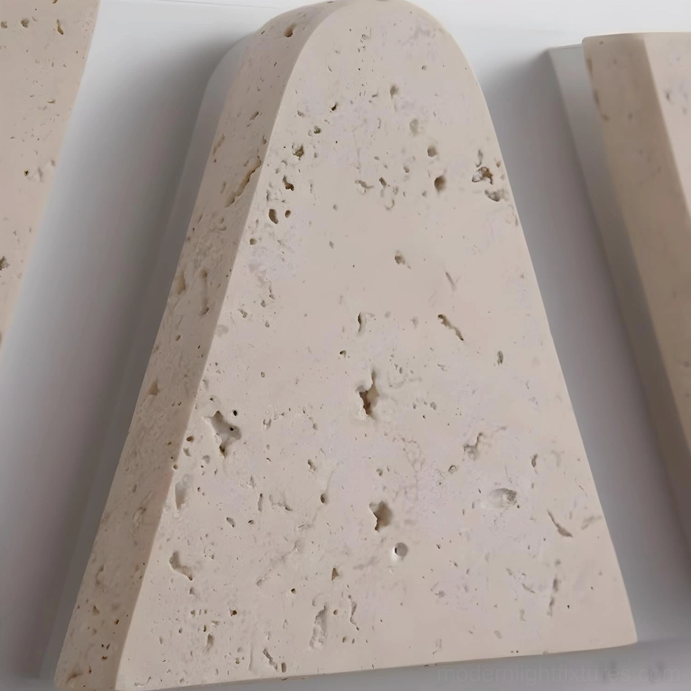 Monolith wall sconce showing integrated LED warm white light diffusion through stone