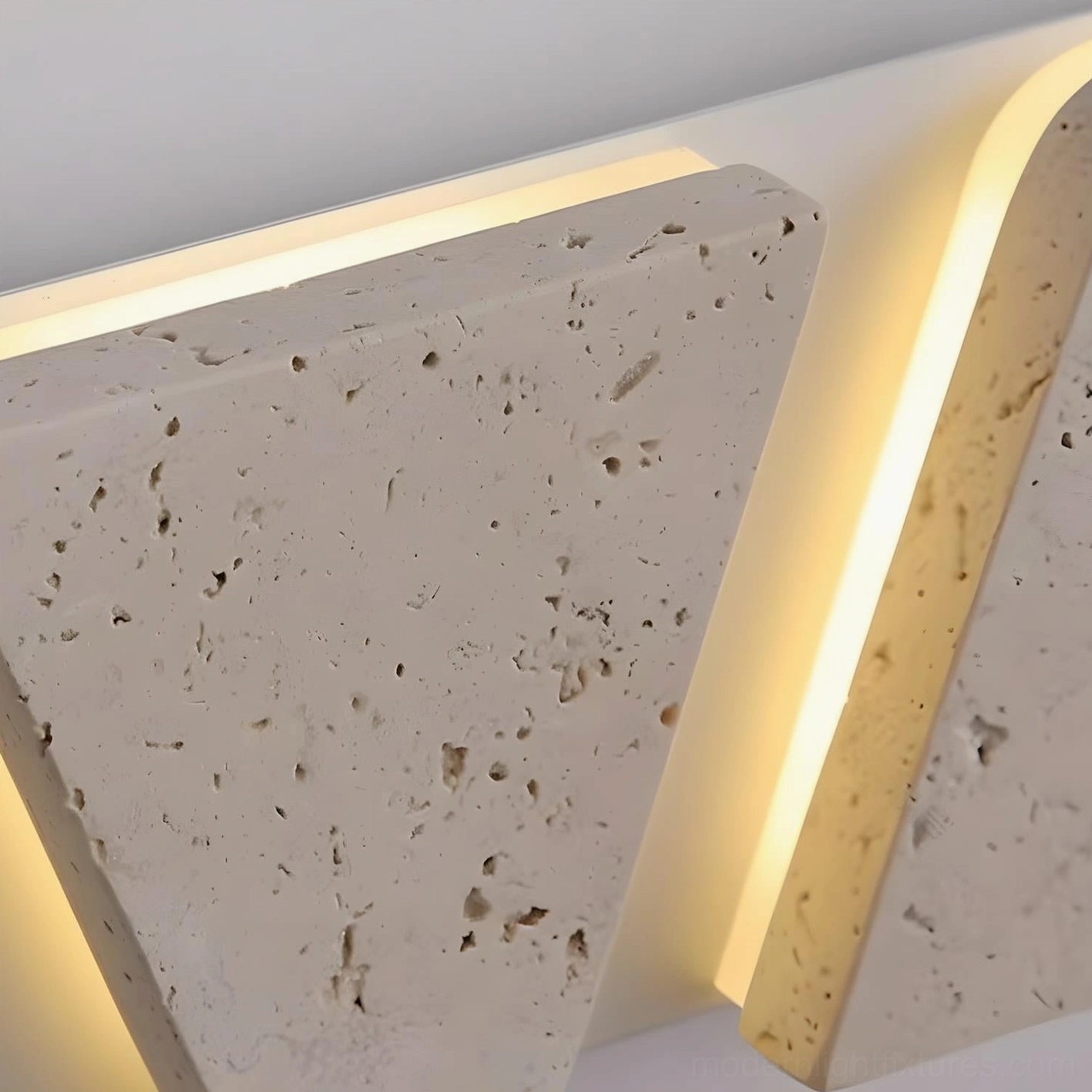 Monolith geometric travertine wall sconce detail showing staggered triangular panel arrangement