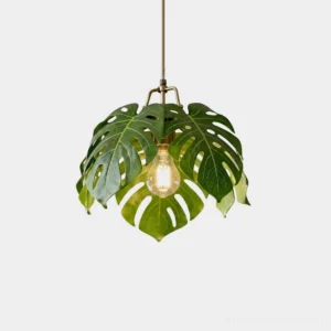 Monstera leaf pendant light front view featuring layered resin leaves with gold brass detailing on white background