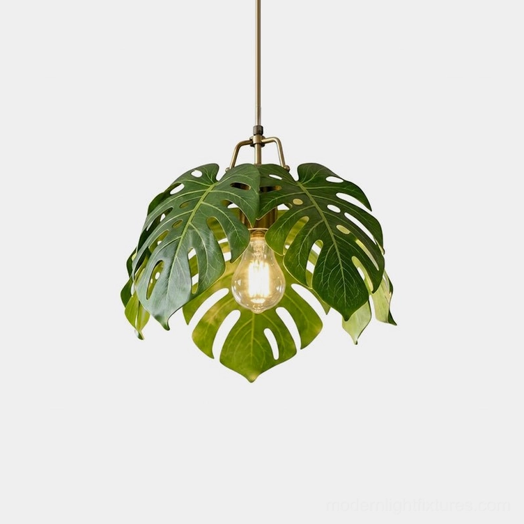 Monstera leaf pendant light front view featuring layered resin leaves with gold brass detailing on white background