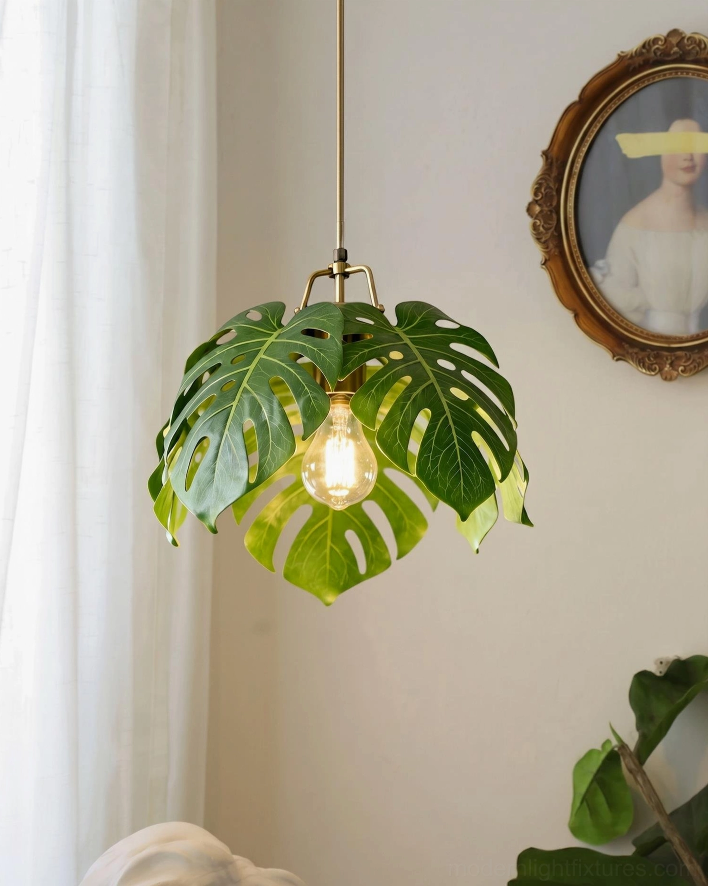 Monstera leaf pendant light in entry hallway creating botanical focal point with vintage round mirror wall decor