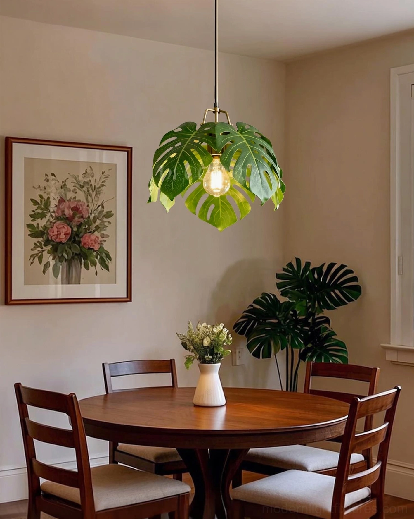 Monstera leaf pendant light side view in dining space with round wooden table and botanical framed wall art