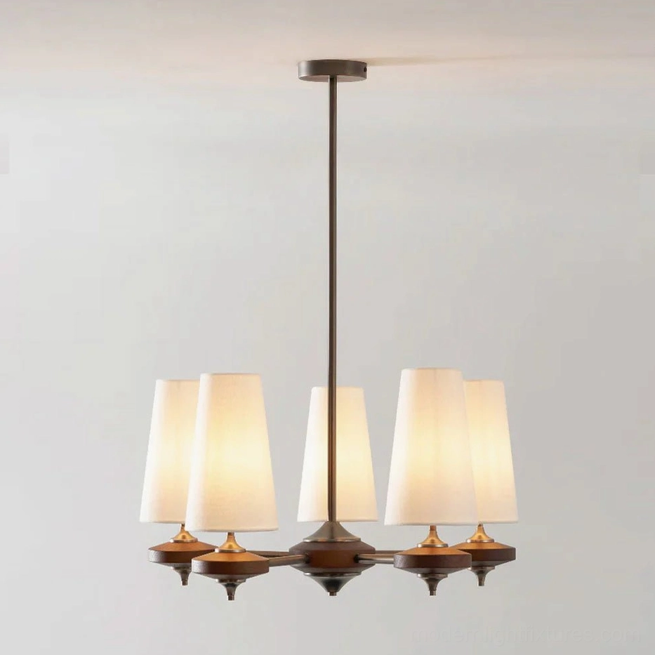 Montera 5-light chandelier with cream-colored tapered fabric cone shades, bronze metal hardware, shown suspended in modern interior space
