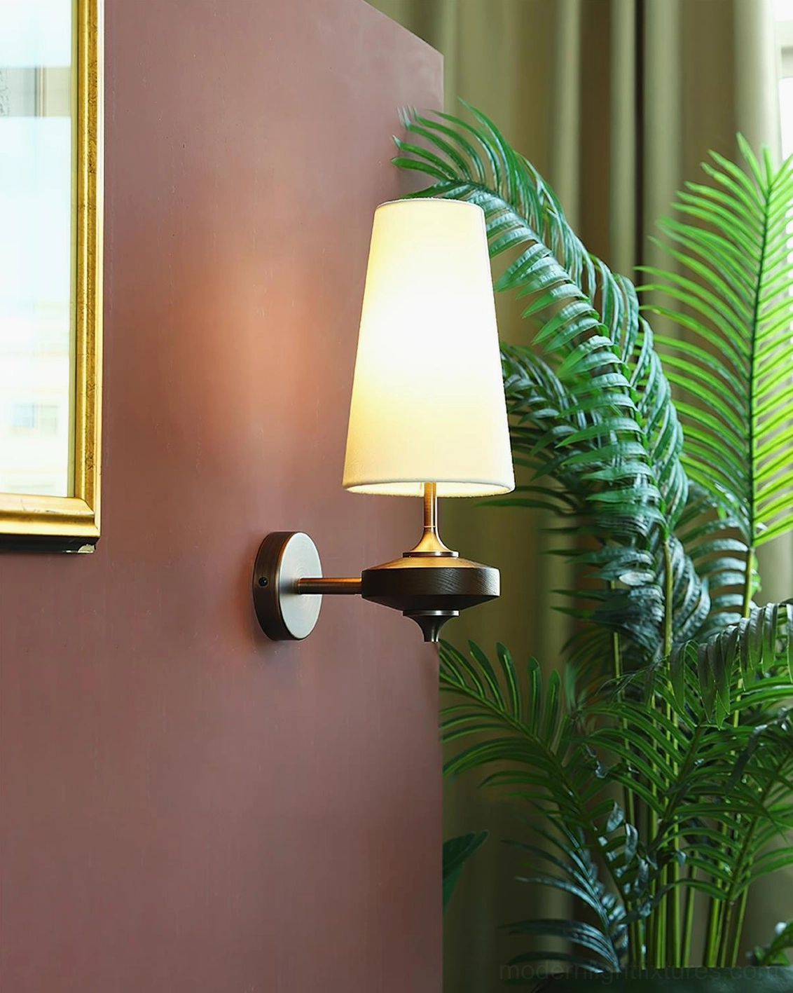 Montera modern wall sconce paired with mirror or artwork in gallery-style wall display arrangement