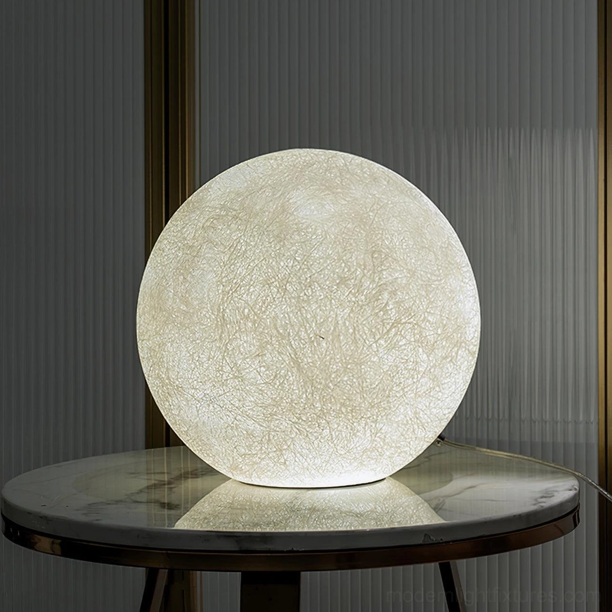 Moon table lamp three-quarter view on marble side table modern living room interior styling