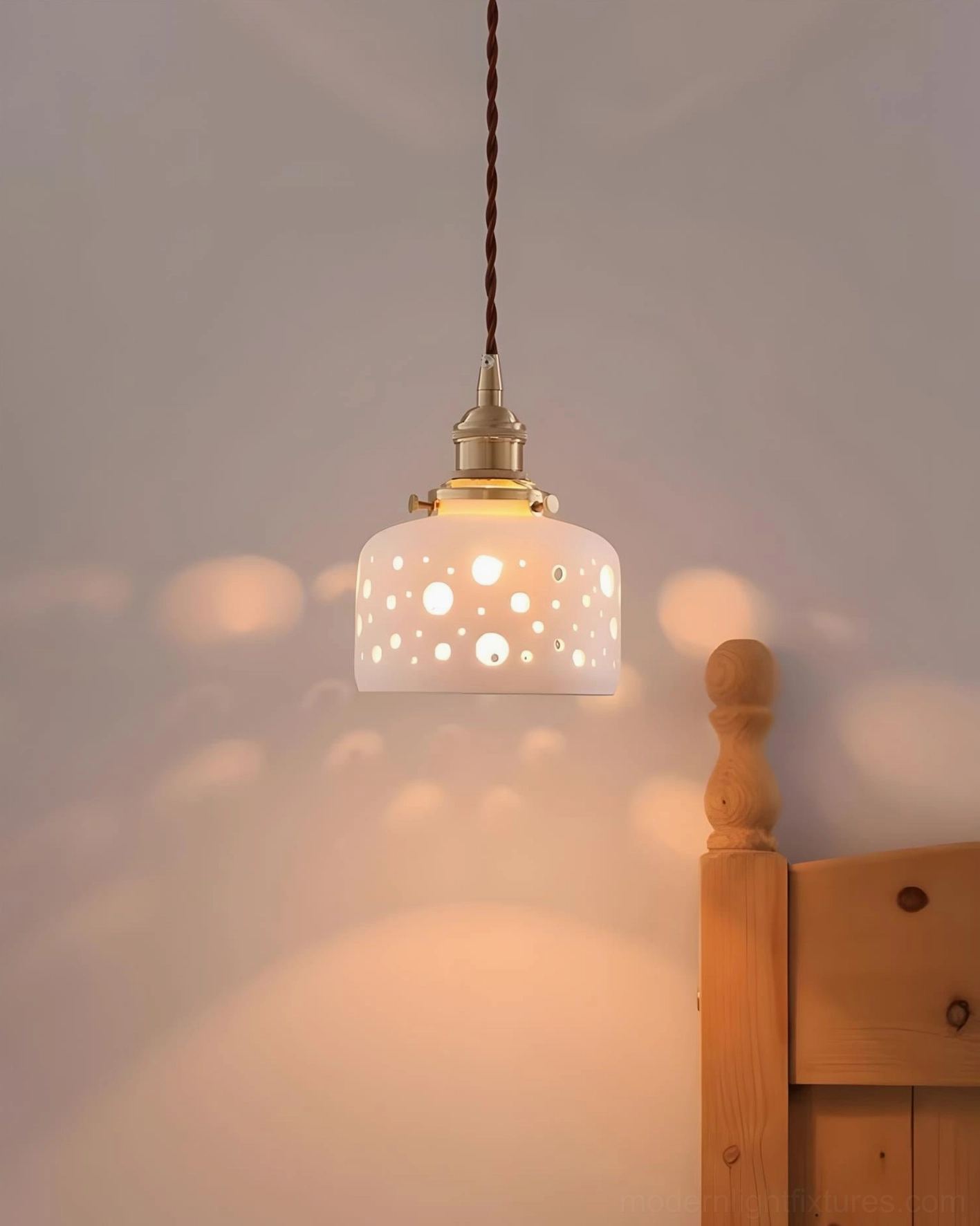 Moonveil ceramic cutout pendant light detail shot emphasizing artisanal craftsmanship and shadow-casting apertures