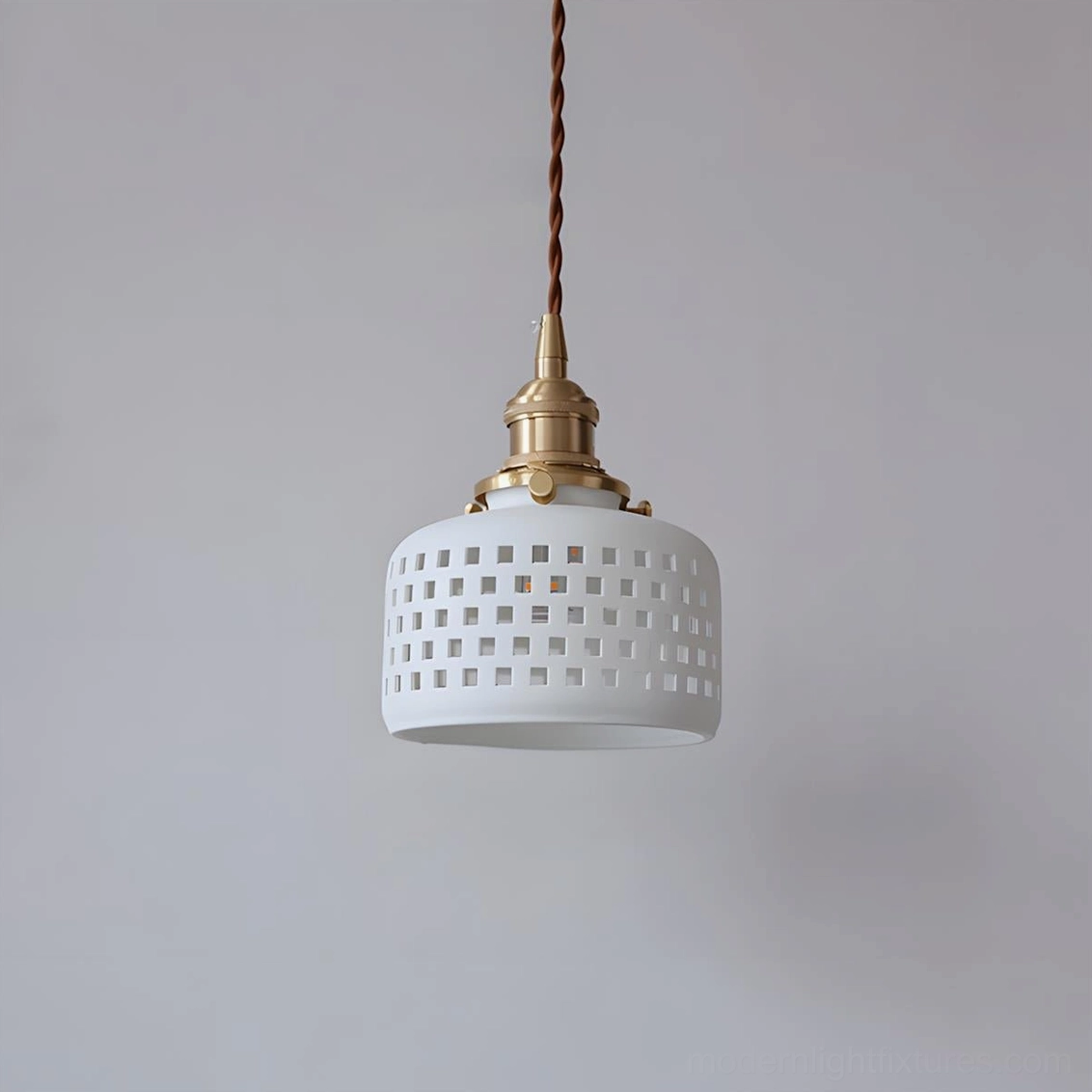 Unlit Moonveil ceramic pendant with square grid hollow perforated shade and brass hardware - front studio shot