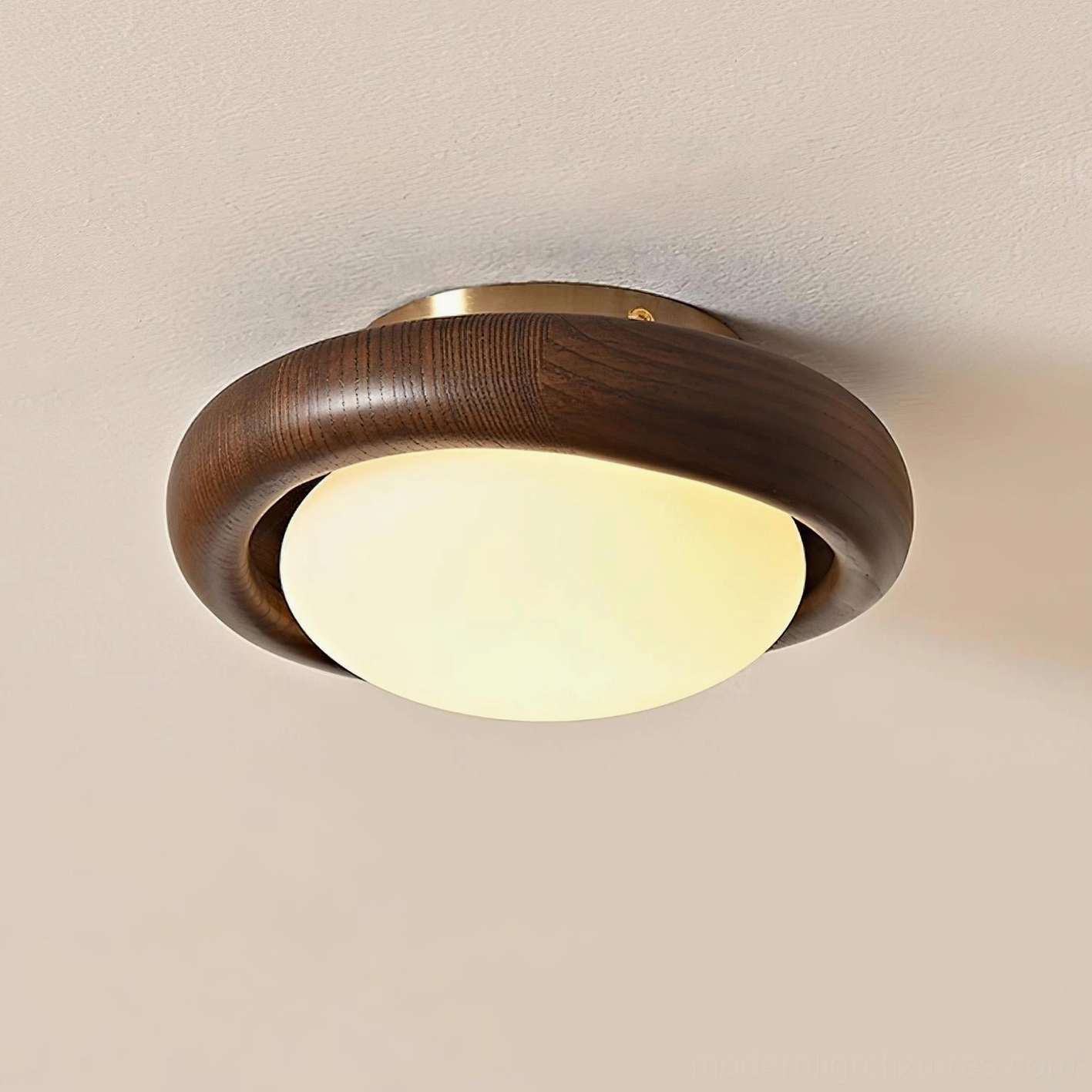 Walnut wood flush mount ceiling lamp installed overhead showing warm glowing frosted dome and dark wood ring trim