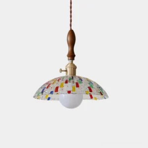 Mosaic stained glass pendant light with colorful glass shade and brass hardware on white background