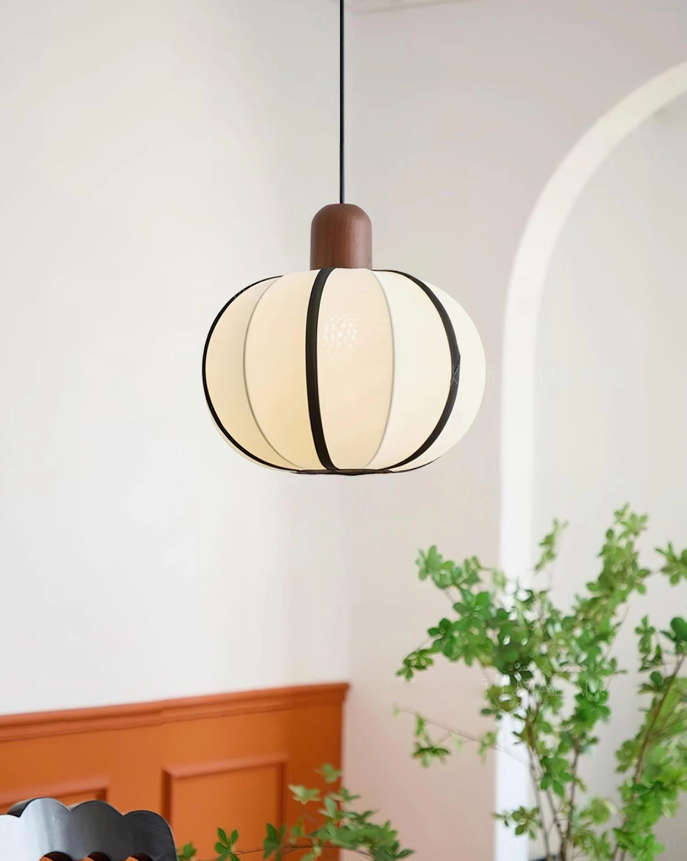 Mosh ribbed fabric globe pendant - side angled view showing textured off-white shade with black stripe details and natural wood connector in botanical room setting