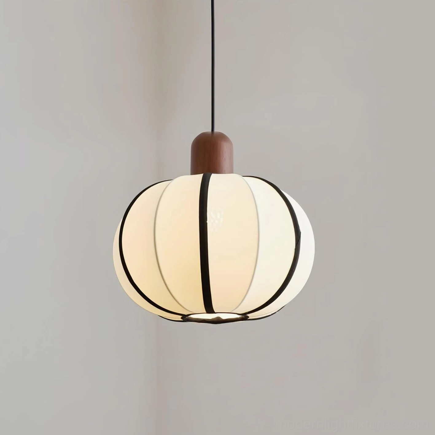 Mosh ribbed fabric globe pendant lamp close-up studio view - full detail of cream off-white textured shade with black stripe trim and walnut wood top cap